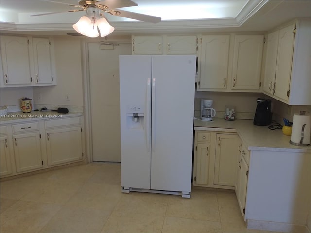 kitchen with light tile patterned flooring, white cabinetry, white refrigerator with ice dispenser, and ceiling fan