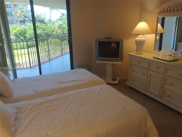 carpeted bedroom featuring access to outside