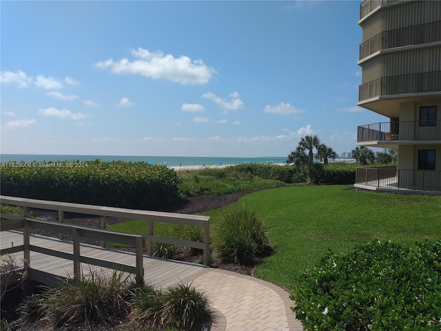 exterior space featuring a balcony and a water view