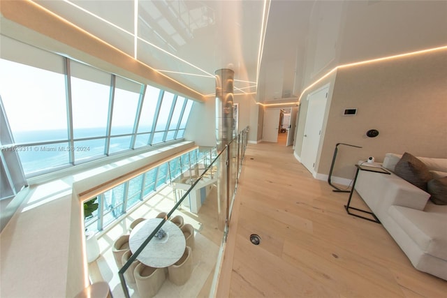 interior space with a water view and light hardwood / wood-style floors