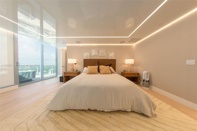 bedroom featuring light hardwood / wood-style floors and access to exterior