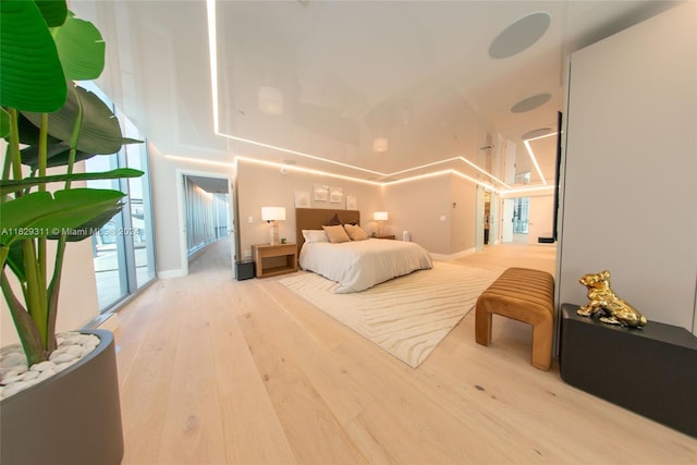 bedroom featuring wood-type flooring and a towering ceiling