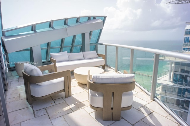 balcony with an outdoor living space and a water view