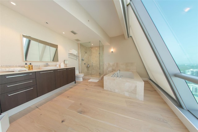 full bathroom with independent shower and bath, vanity, toilet, and hardwood / wood-style floors