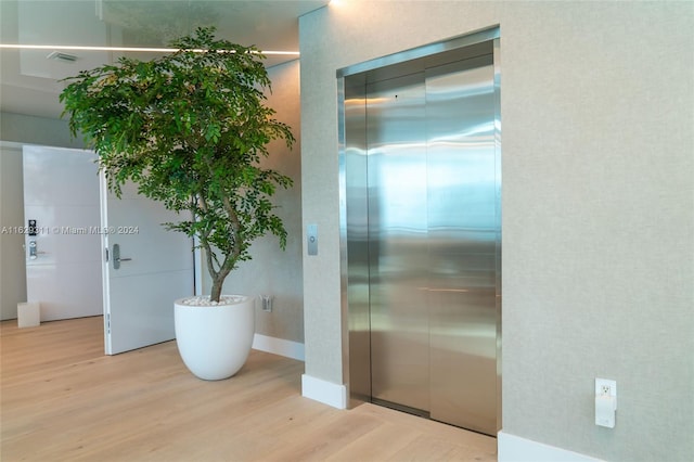 interior space with light hardwood / wood-style flooring and elevator