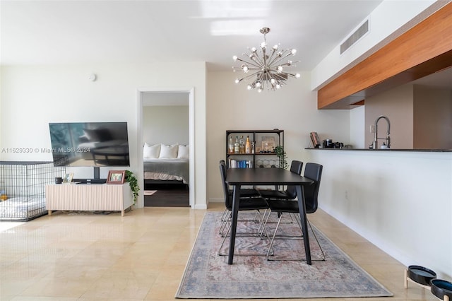 dining room with a notable chandelier and sink