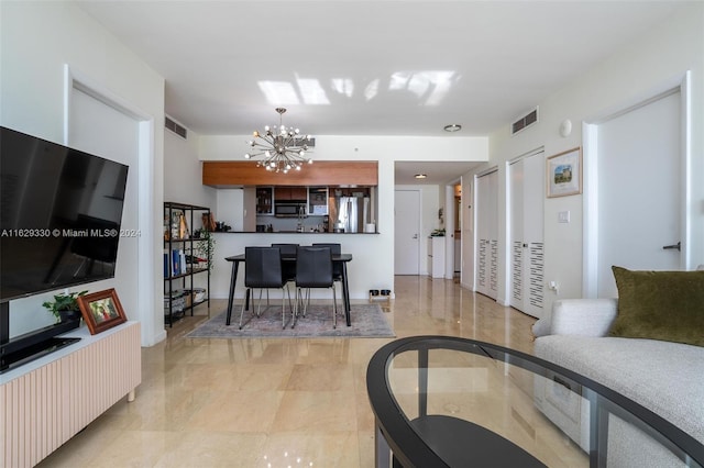 living room featuring a notable chandelier