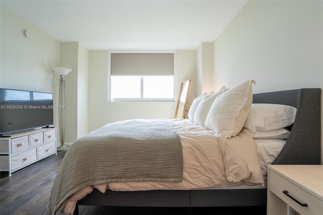 bedroom with dark hardwood / wood-style flooring