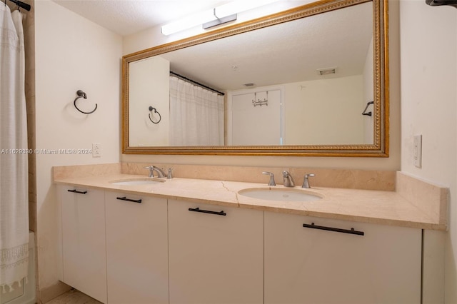 bathroom with vanity and curtained shower