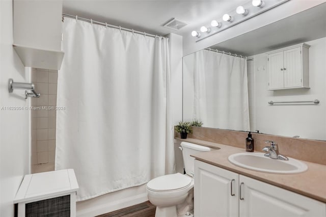 bathroom with vanity, toilet, hardwood / wood-style flooring, and curtained shower