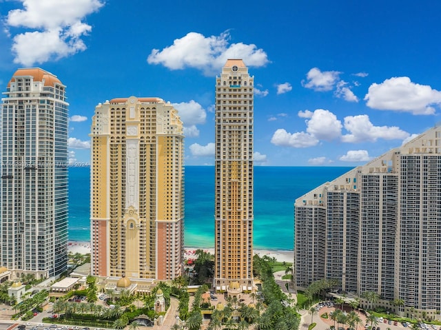 view of city with a beach view and a water view