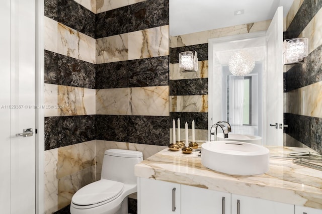 bathroom featuring tile walls, toilet, and vanity