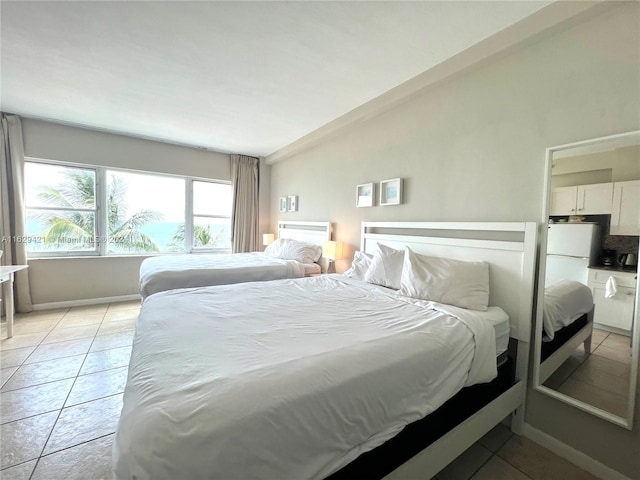 bedroom with lofted ceiling and light tile patterned floors