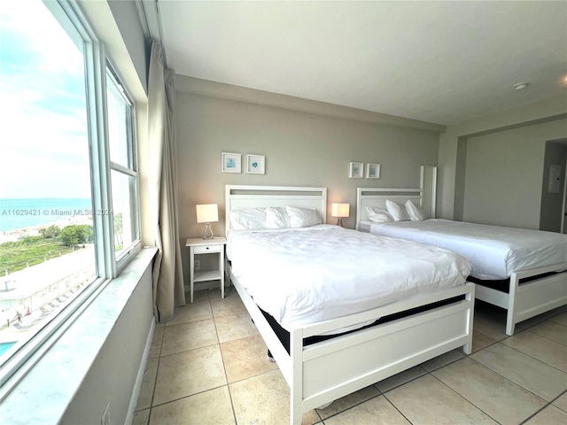 tiled bedroom with a water view