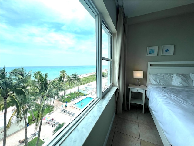 tiled bedroom with a water view