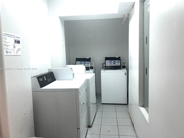 laundry area featuring separate washer and dryer and light tile patterned flooring