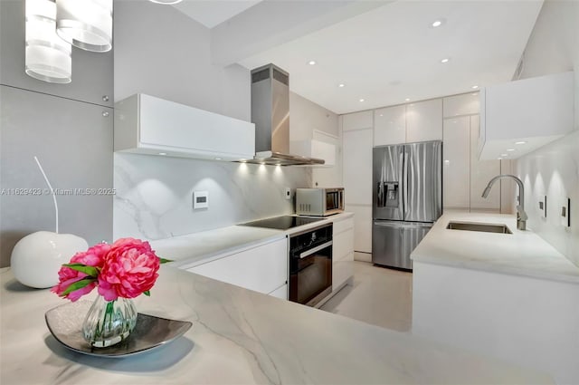 kitchen featuring black appliances, white cabinetry, sink, hanging light fixtures, and island range hood