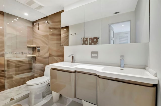 bathroom with a shower with door, tile walls, toilet, and vanity