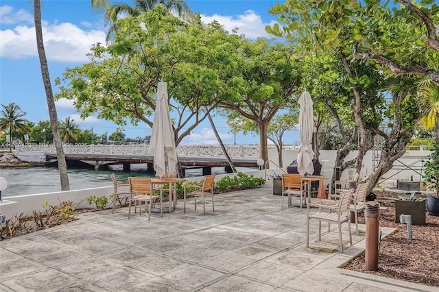 view of property's community featuring a patio area and a water view