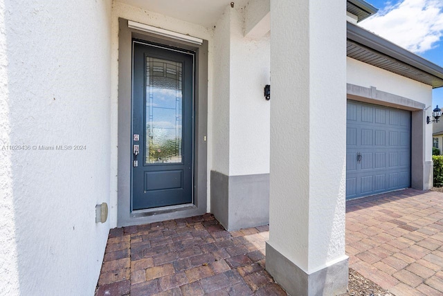 view of exterior entry featuring a garage