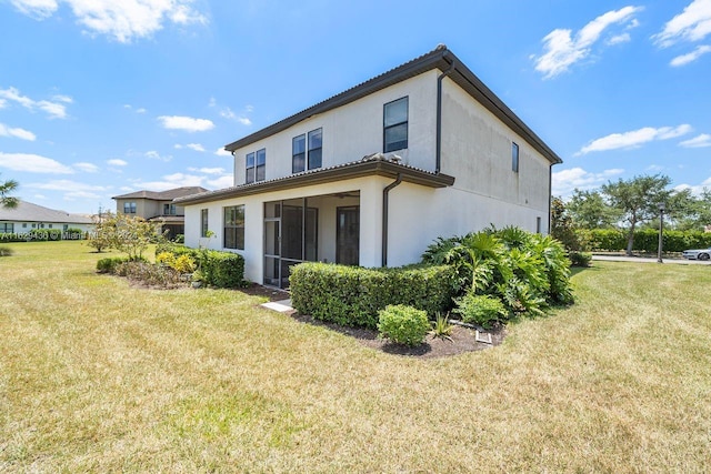 rear view of house with a lawn