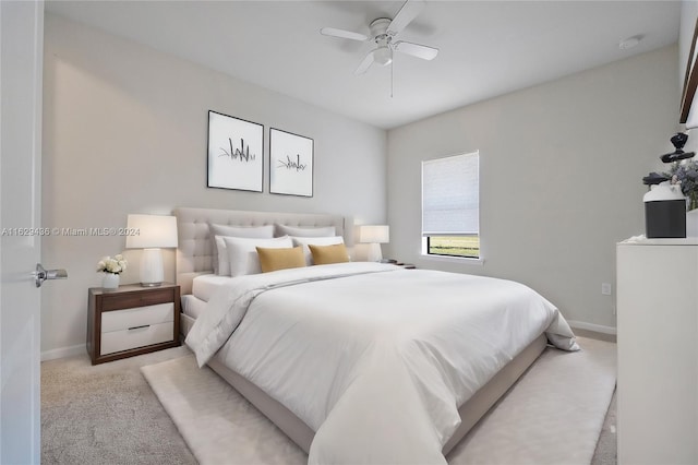 bedroom with light carpet and ceiling fan