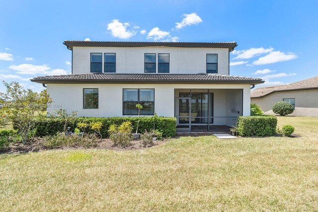 rear view of property with a yard