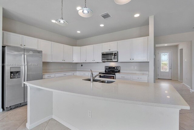 kitchen featuring light tile patterned flooring, sink, stainless steel appliances, and white cabinets