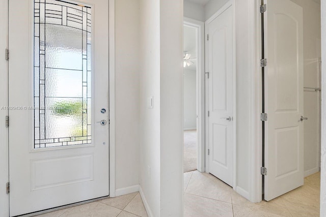 tiled entrance foyer with ceiling fan