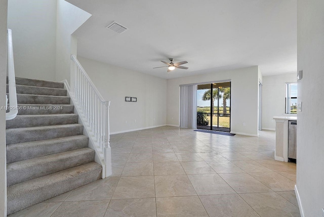 unfurnished living room with ceiling fan and light tile patterned flooring