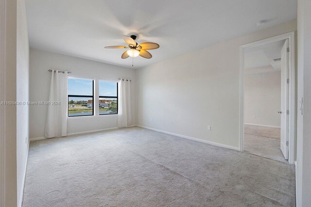 carpeted empty room with ceiling fan