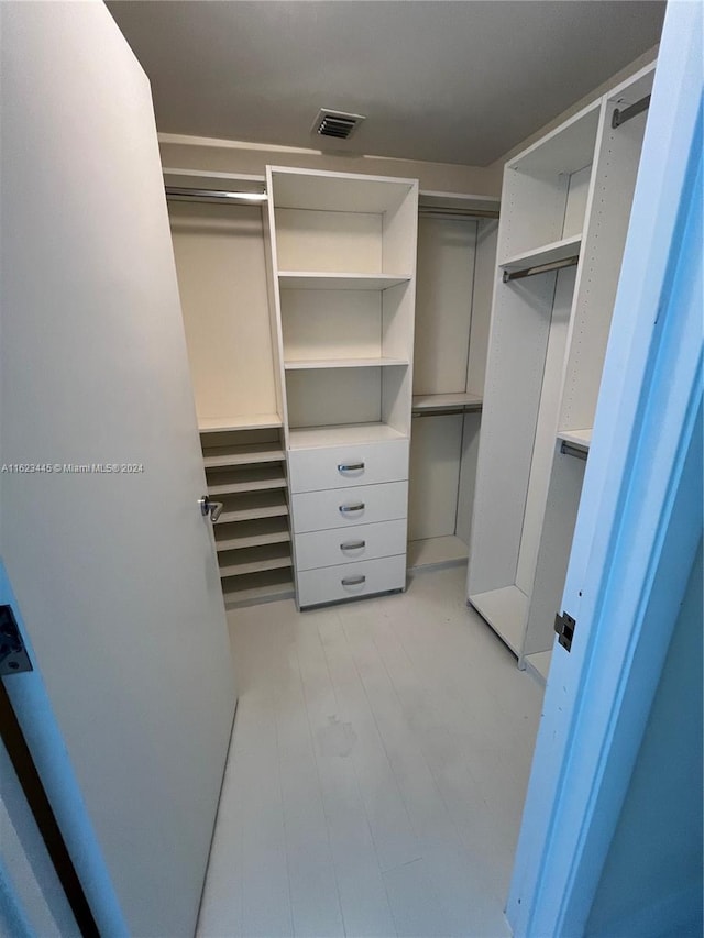 spacious closet with light hardwood / wood-style flooring