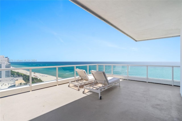 balcony with a view of the beach and a water view