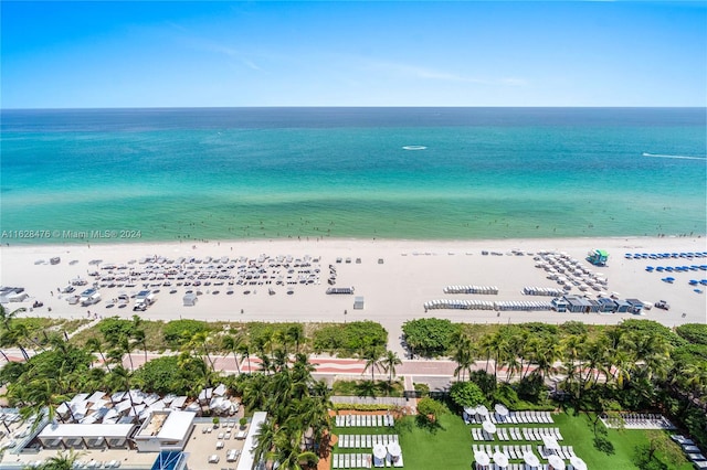 birds eye view of property featuring a beach view and a water view