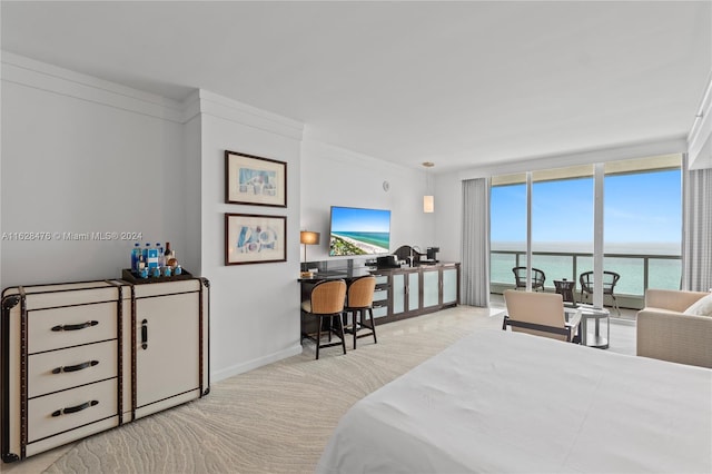 bedroom with a wall of windows, light carpet, and crown molding