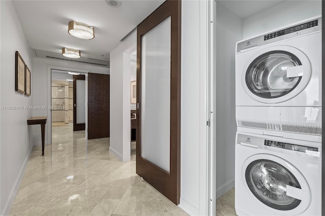 laundry area featuring stacked washer and clothes dryer