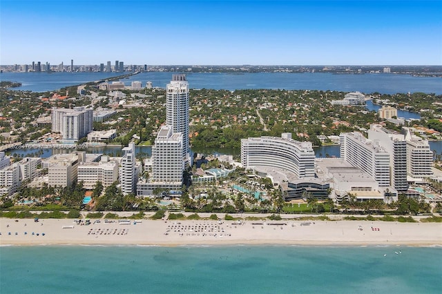 birds eye view of property with a view of the beach and a water view