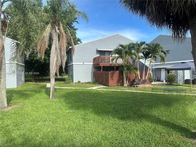 exterior space featuring a balcony, cooling unit, and a front lawn