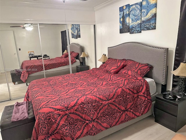 bedroom with ceiling fan, crown molding, a closet, and light hardwood / wood-style floors