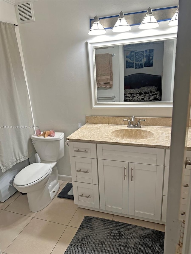 bathroom with vanity, tile patterned flooring, and toilet