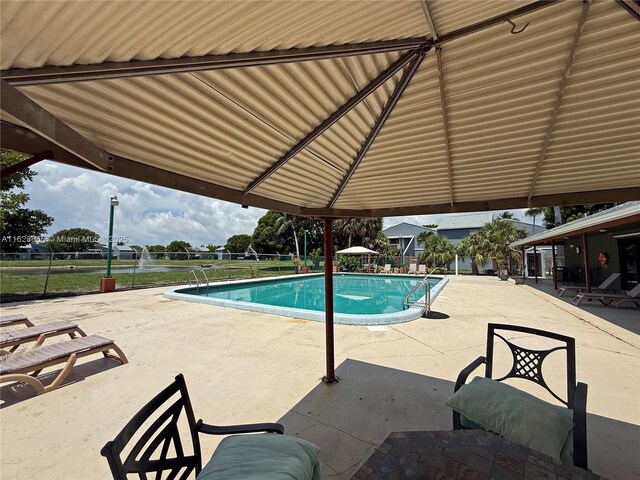 22 Crossings Cir Unit E, Boynton Beach, FL 33435 - view of swimming pool featuring a patio