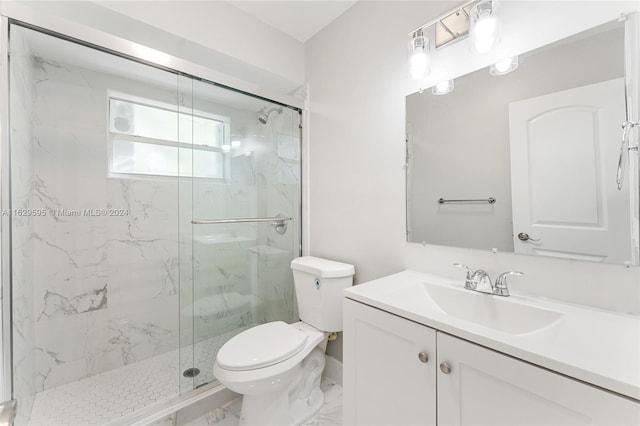 bathroom featuring vanity, toilet, and a shower with door