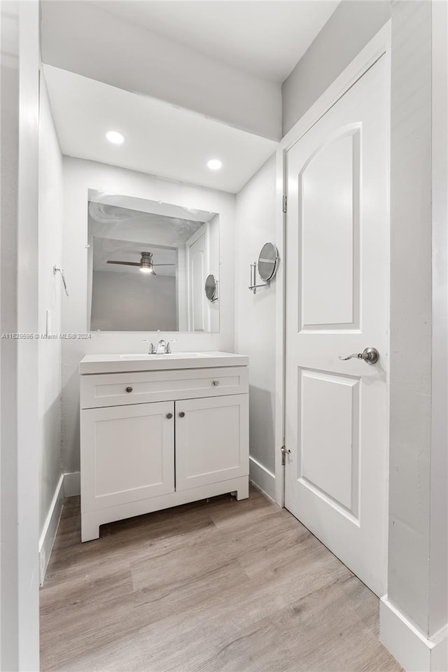 bathroom featuring ceiling fan, vanity, and hardwood / wood-style flooring