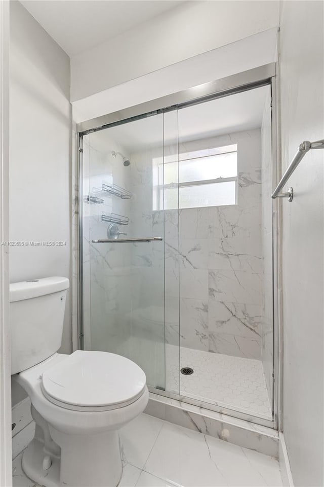 bathroom with toilet and walk in shower