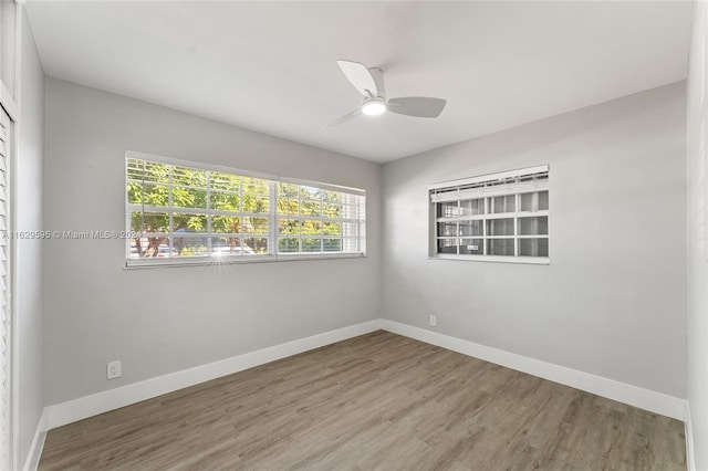 unfurnished room with hardwood / wood-style floors, plenty of natural light, and ceiling fan