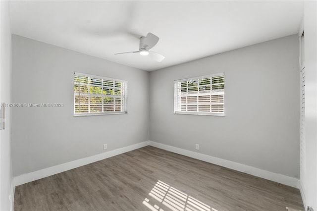 empty room with a wealth of natural light, ceiling fan, and light wood-type flooring