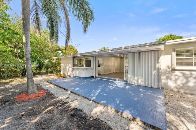 rear view of property featuring a patio