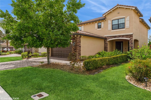 mediterranean / spanish-style home with a front lawn and a garage