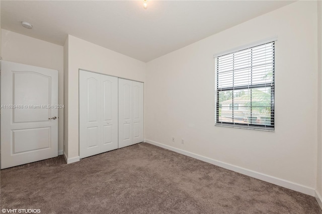 unfurnished bedroom featuring a closet and carpet