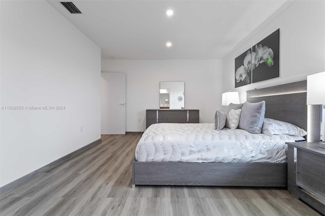 bedroom with wood-type flooring